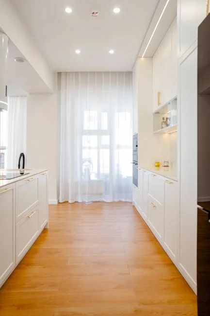 Anonymous person in yellow rubber gloves using simple sponge for cleaning mirror in bathroom